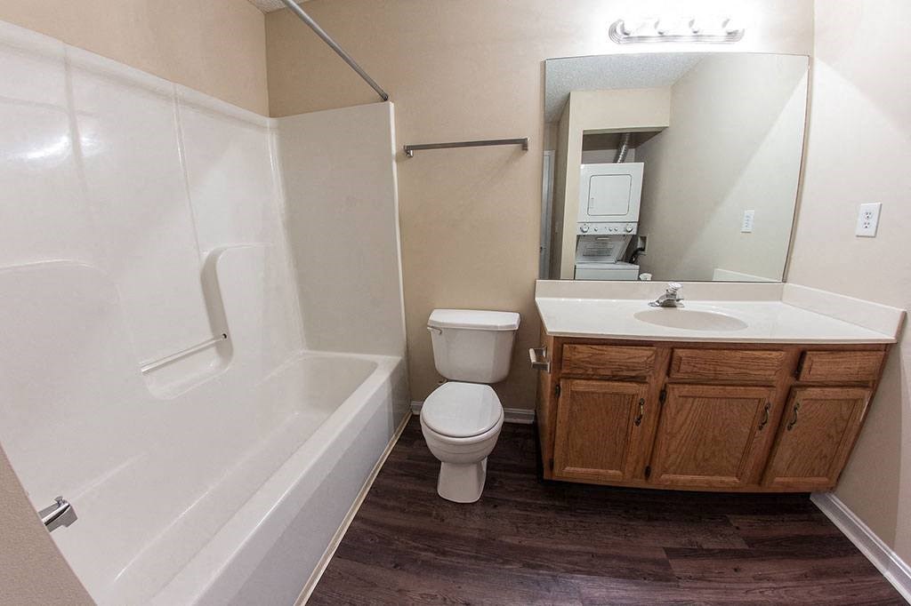 a bathroom with a toilet and a sink and a bath tub