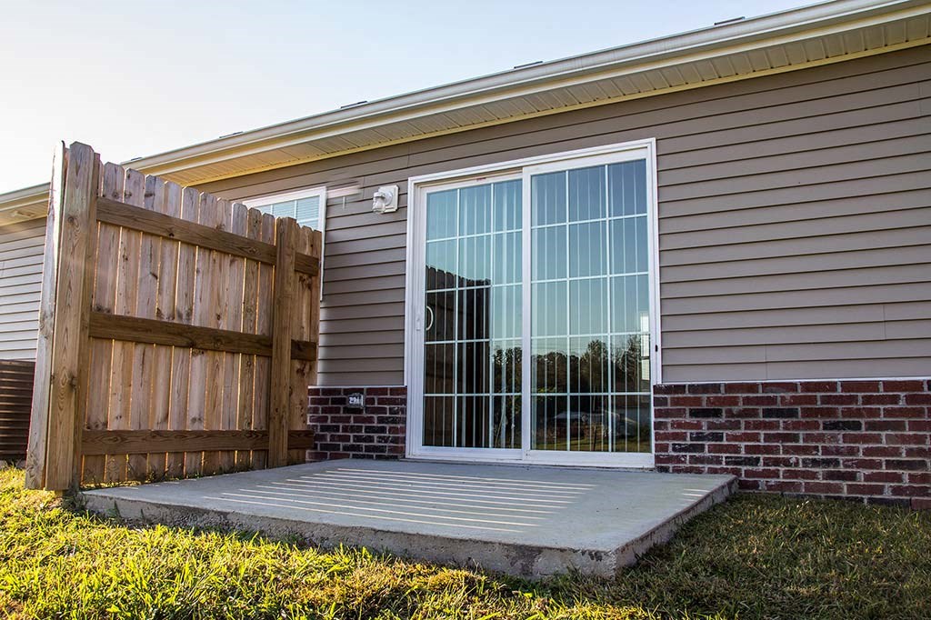 a house with a porch and a sliding glass door