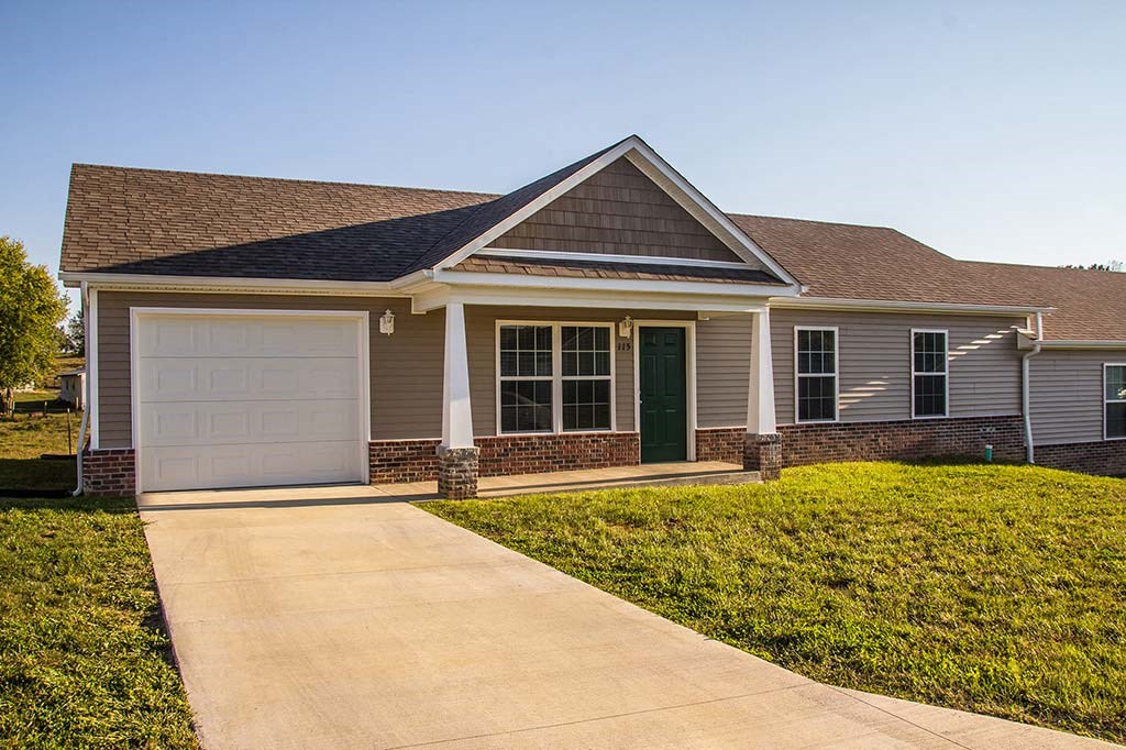 a house with a driveway and a white garage door