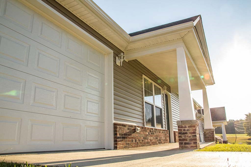 a white garage door on the side of a house