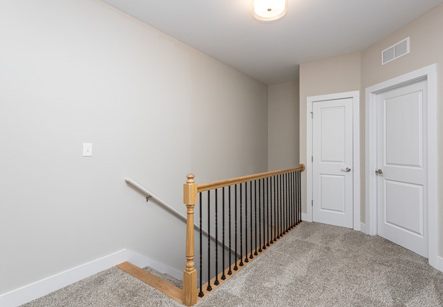 A room with a staircase and two doors.