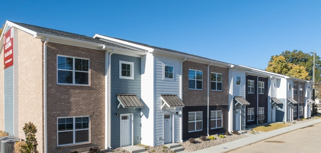 A row of townhouses with different colored exteriors.