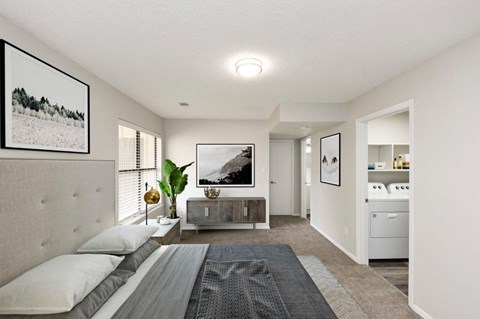 a bedroom with a bed and a dresser and a bathroom