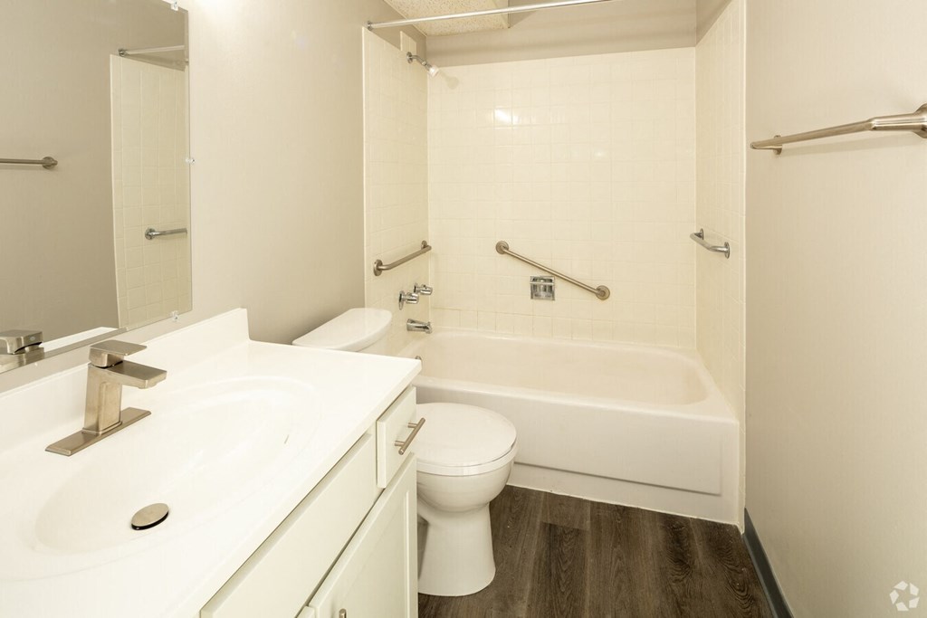 a bathroom with a sink toilet and a bath tub