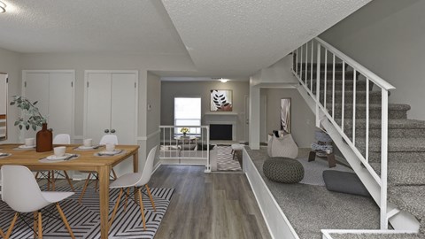 a living room and dining room with a staircase