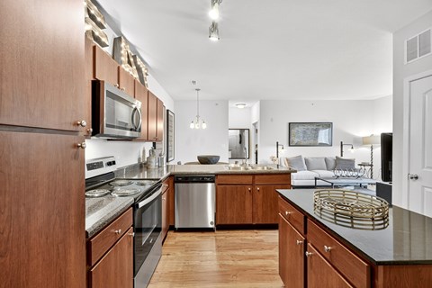 A modern kitchen with wooden cabinets and stainless steel appliances.
