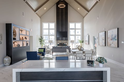 a large living room with a table and chairs and a fireplace