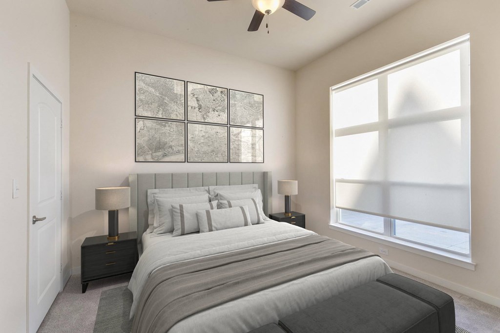 A bedroom with a large bed and a ceiling fan.