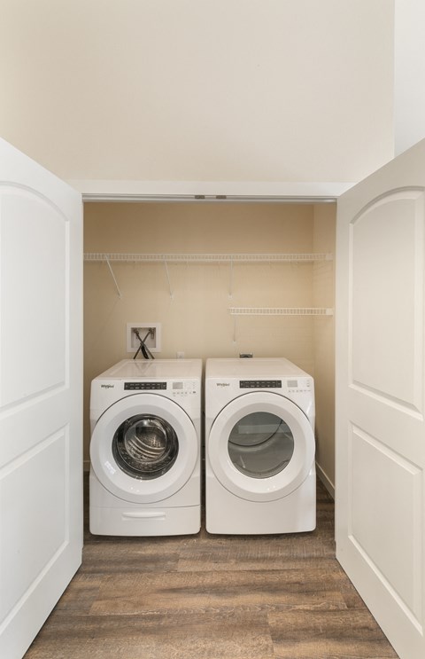 a washer and dryer in a laundry room with white doors