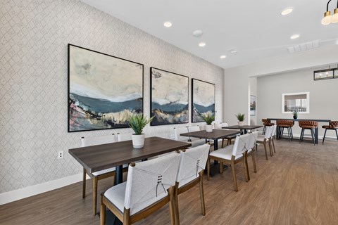 A dining room with a long table and chairs.