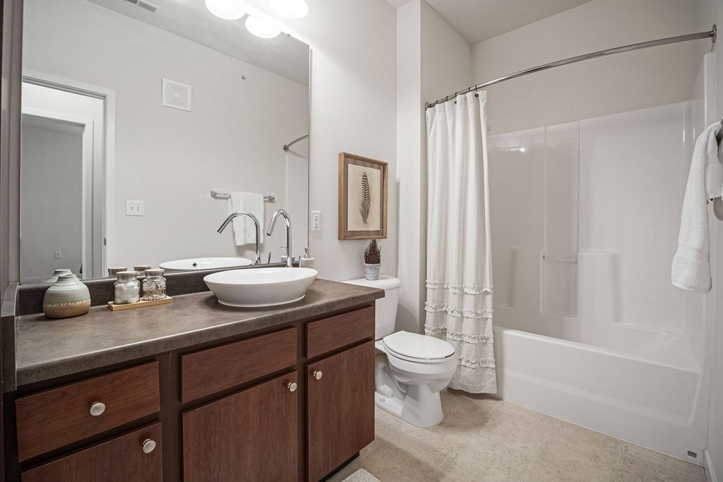 A bathroom with a white toilet and a white bathtub. at Aventura at Richmond, St. Peters, MO, 63376