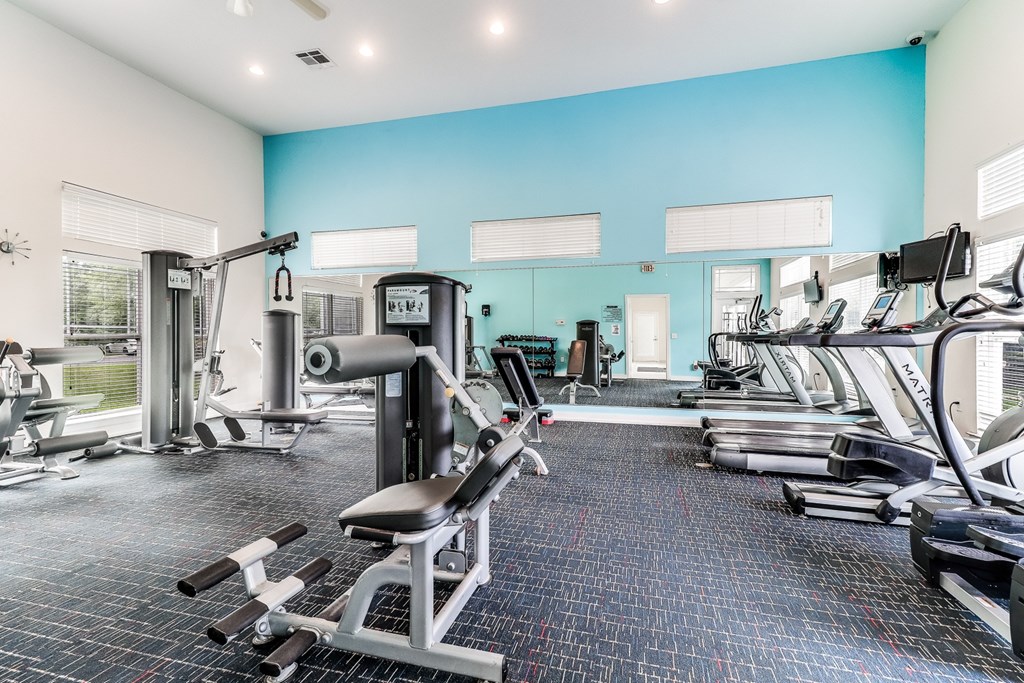 A spacious gym with a variety of equipment including treadmills, weight machines, and free weights, Plantation Crossing, Lafayette, LA, 70508