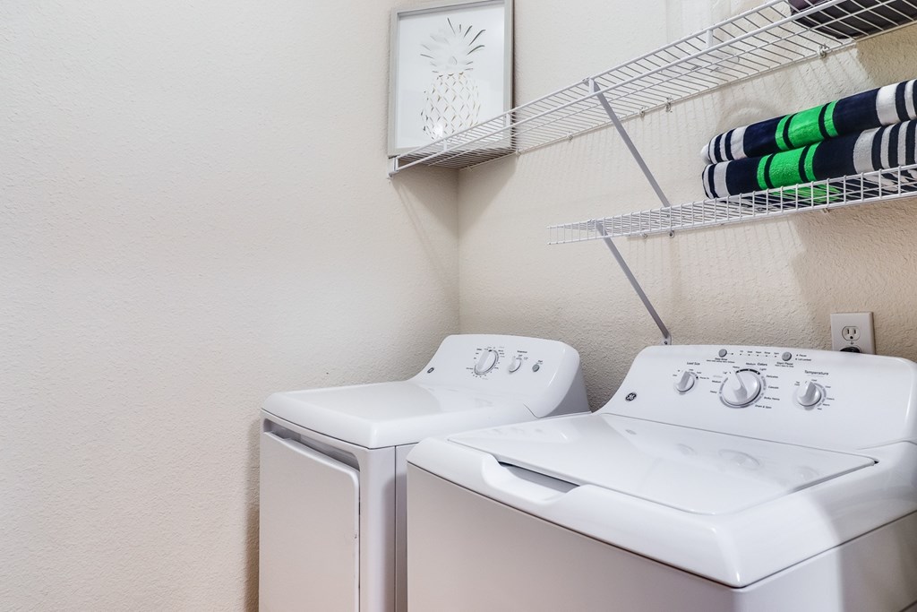 A white washing machine and dryer in a laundry room, Plantation Crossing, Lafayette, LA, 70508