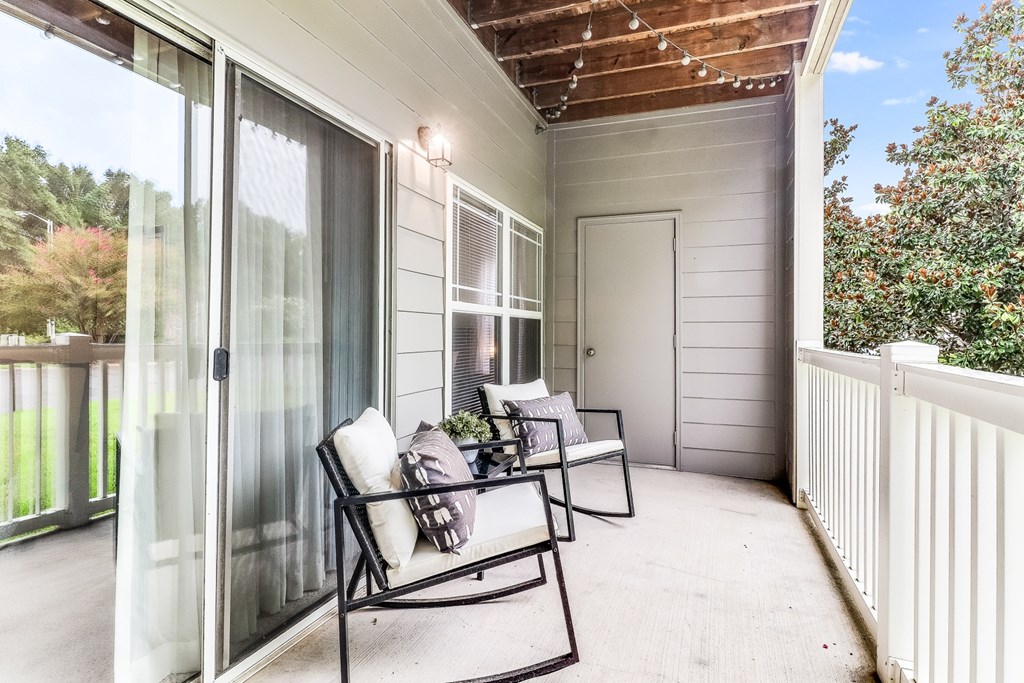 A patio with a table and chairs is shown, Plantation Crossing, Lafayette, LA, 70508