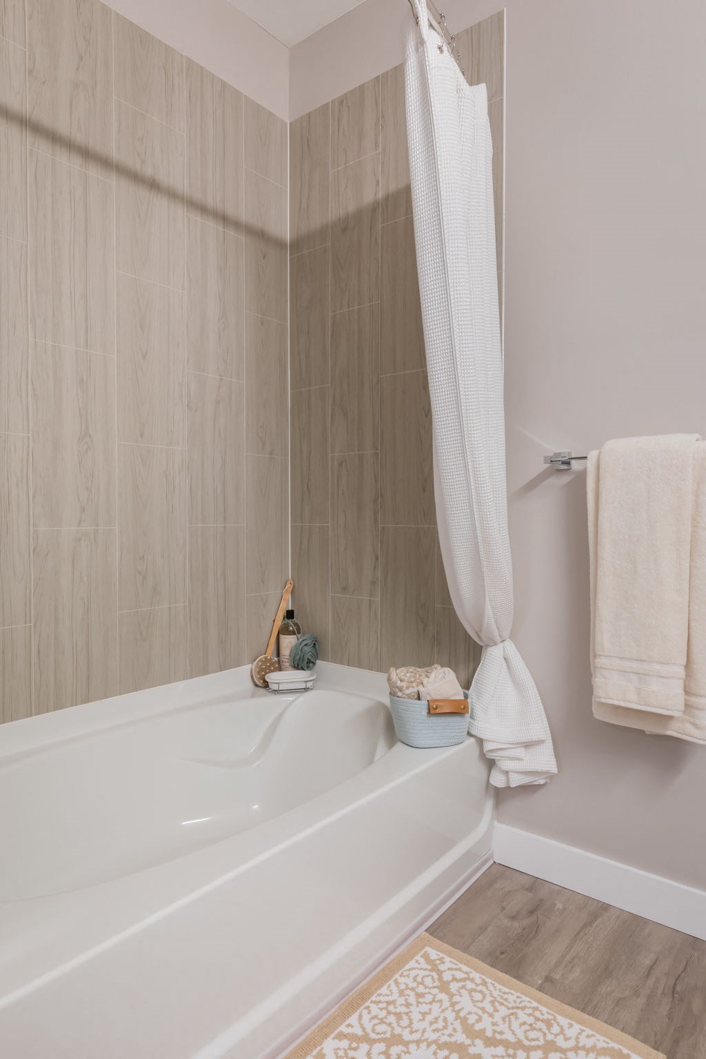 a bathroom with a white bathtub and a white shower curtain  at The Edison at Tiffany Springs, Kansas City, MO, 64153