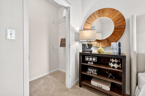 A room with a round mirror and a wooden shelf with a sign that says "Paws New York".