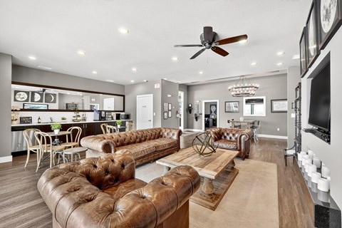 A living room with brown leather sofas and a wooden coffee table.