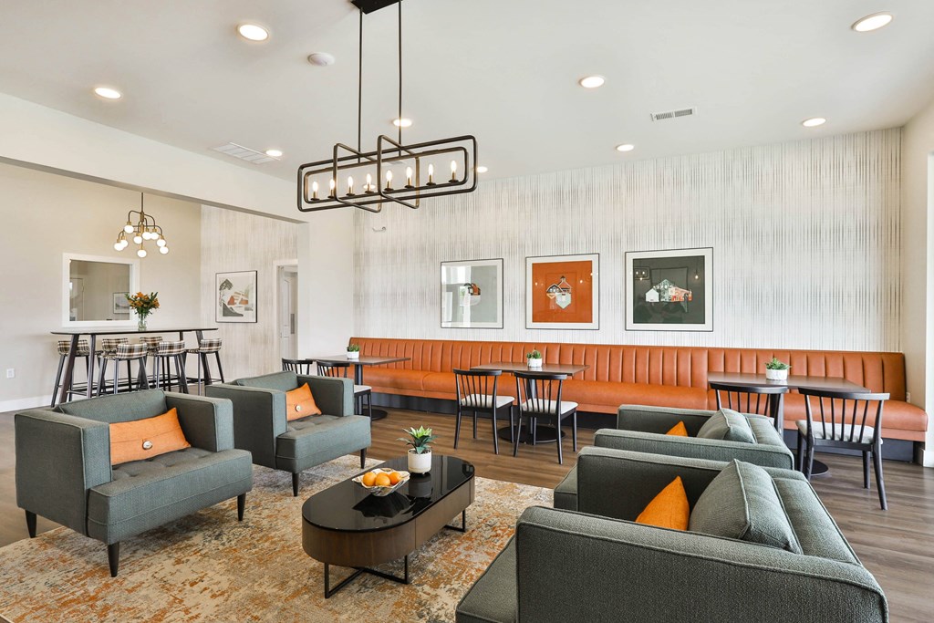 a living room with couches and chairs and a dining room with tables  at Aventura at Hawk Ridge, Lake St Louis, 63367