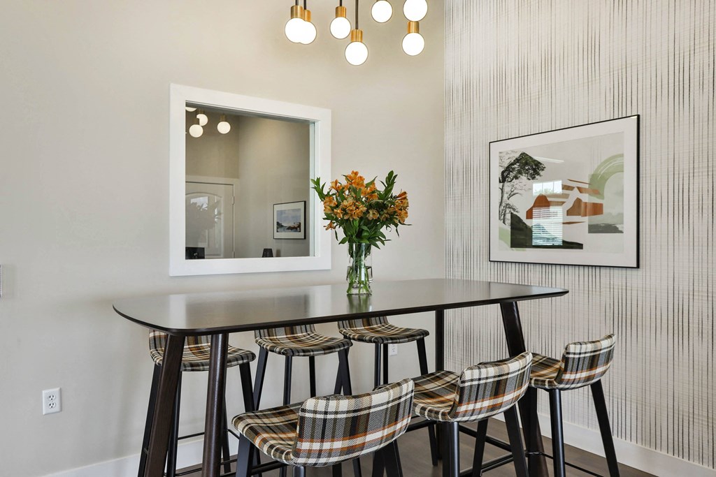 a dining room with a table and chairs and a mirror  at Aventura at Hawk Ridge, Lake St Louis, MO