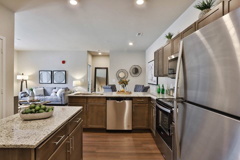 a kitchen with stainless steel appliances and granite counter tops