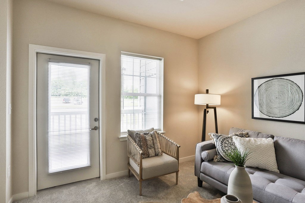 a living room with a couch and a chair  at Aventura at Hawk Ridge, Lake St Louis