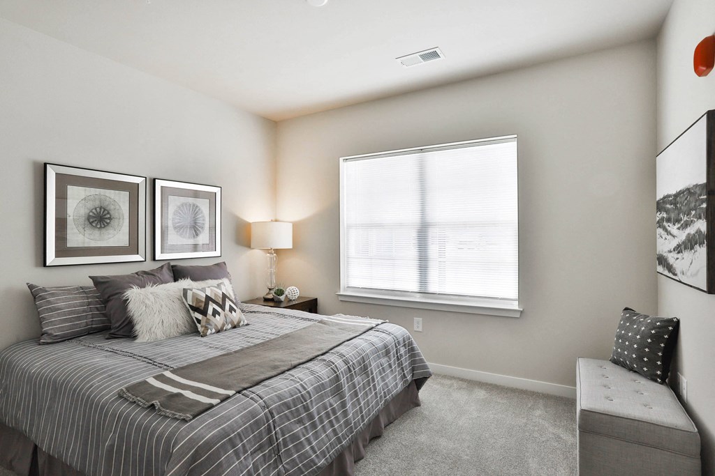 a bedroom with a bed and a window  at Aventura at Hawk Ridge, Lake St Louis, 63367