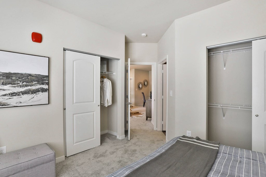 a bedroom with a bed and a closet  at Aventura at Hawk Ridge, Lake St Louis