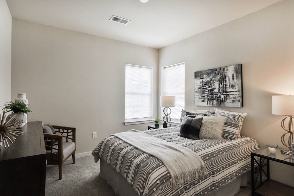 a bedroom with a bed and two windows at Aventura at Aventura at Hawk Ridge, Missouri