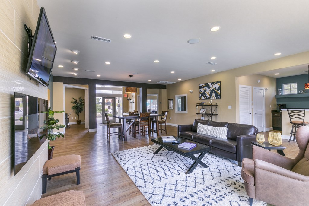 a living room filled with furniture and a flat screen tv at Aventura at Richmond, St. Peters