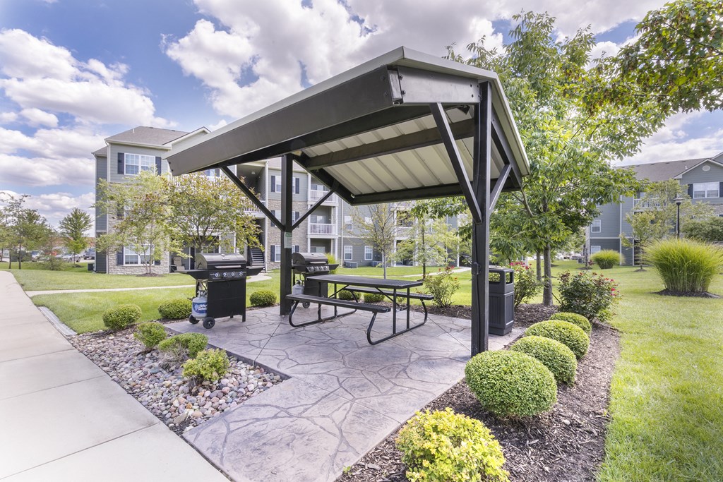 an outdoor patio with a picnic table and a gazebo  at Aventura at Richmond, Missouri, 63376