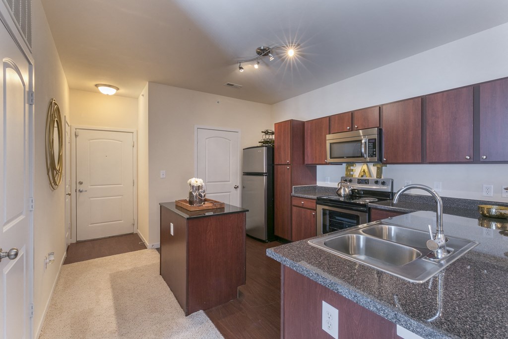 a kitchen with stainless steel appliances and granite counter tops  at Aventura at Richmond, St. Peters, Missouri