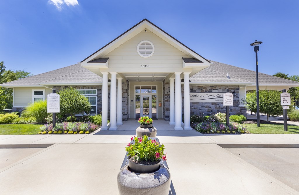 the front of a building with flowers in front of it the front of a building with flowers in front of it at Aventura at Towne Centre, Missouri