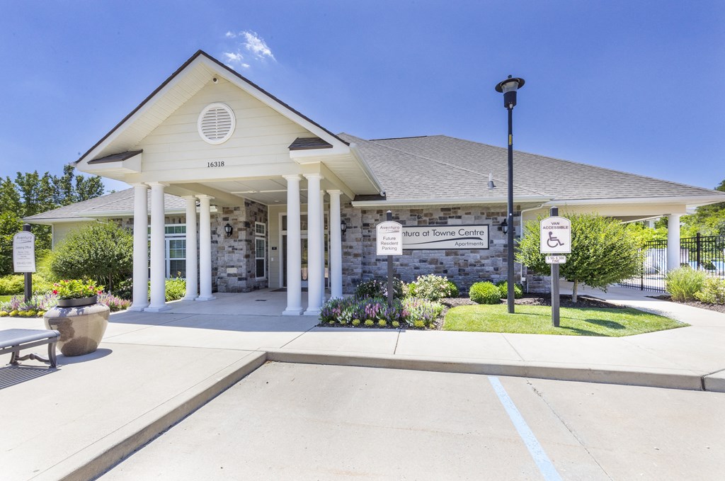 the front entrance of a white building with columns and a porch at Aventura at Towne Centre, Missouri, 63011