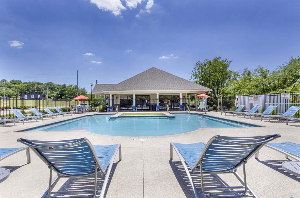 a swimming pool with blue chairs and a pavilion next to a resort style pool at Aventura at Towne Centre, Ellisville, Missouri