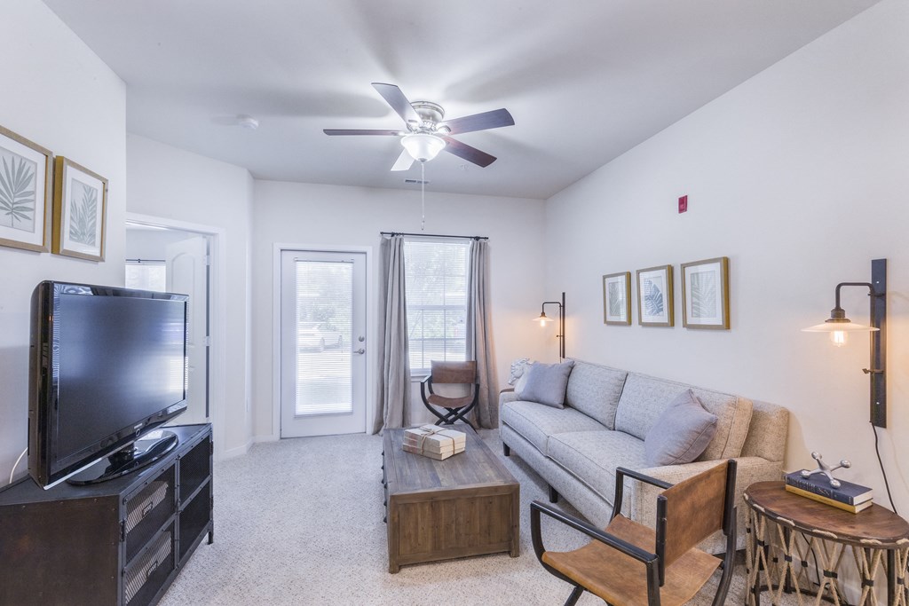 a living room with a couch and a tv at Aventura at Towne Centre, Ellisville, Missouri