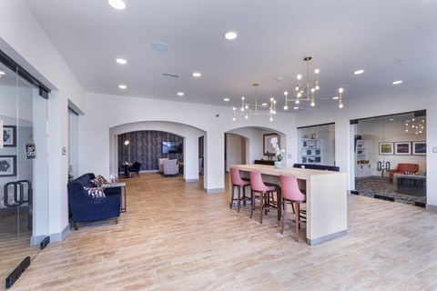 a living room with a kitchen and a dining room at Aventura at Wild Horse Creek, Chesterfield, Missouri