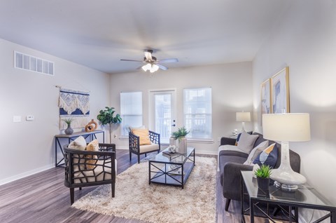 an open living room with a ceiling fan and a window at Aventura at Wild Horse Creek, Chesterfield, MO