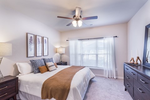a bedroom with a large bed and a ceiling fan at Aventura at Wild Horse Creek, Chesterfield, 63017