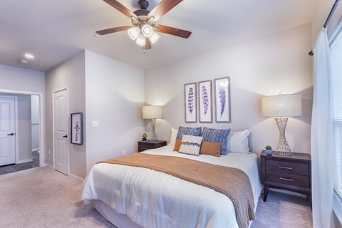 a bedroom with a large bed and a ceiling fan at Aventura at Wild Horse Creek, Chesterfield, MO, 63017
