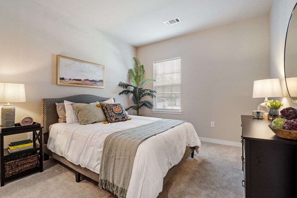 spacious bedroom with a bed and a window  at Aventura at Wentzville, Wentzville, MO