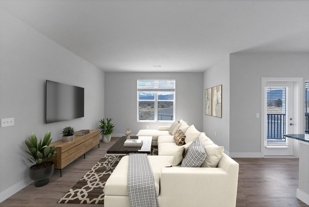 a living room with grey walls and a white couch  at The Edison at Chapel Hills, Colorado Springs