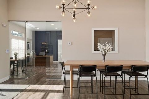 A dining room with a wooden table and chairs.