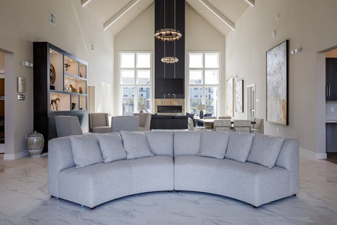 a living room with a large couch and a table with chairs
