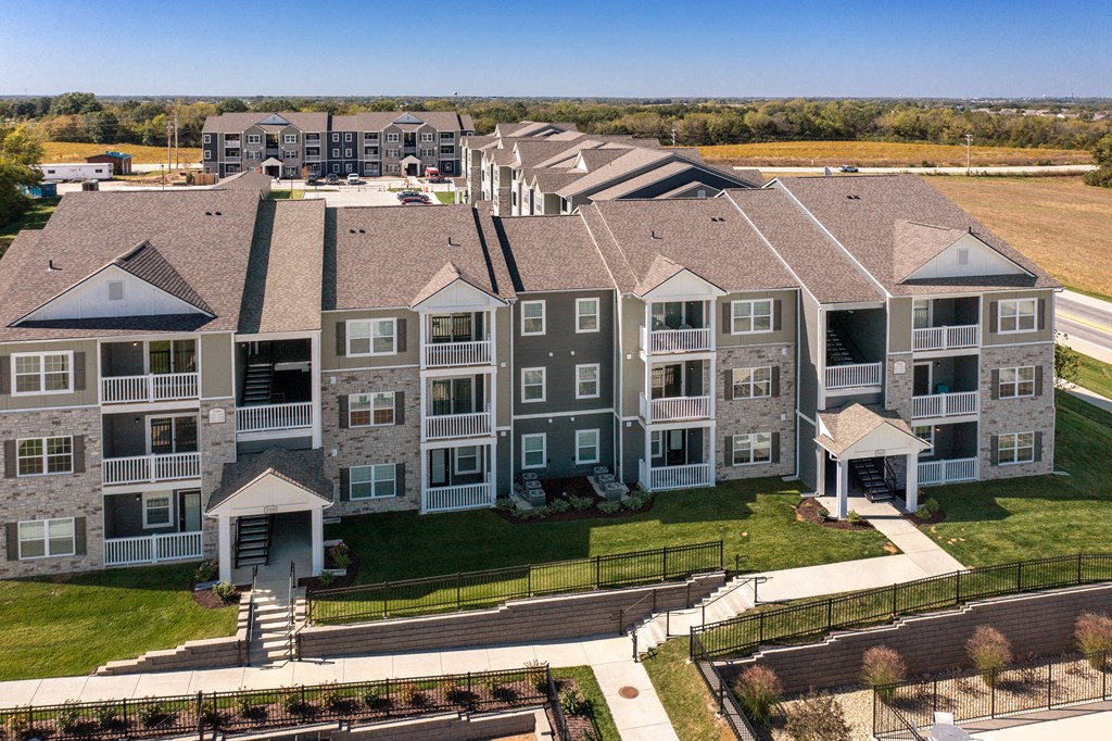 an aerial view of an apartment complex with a field in the background  at Aventura at Hawk Ridge, Lake St Louis, 63367
