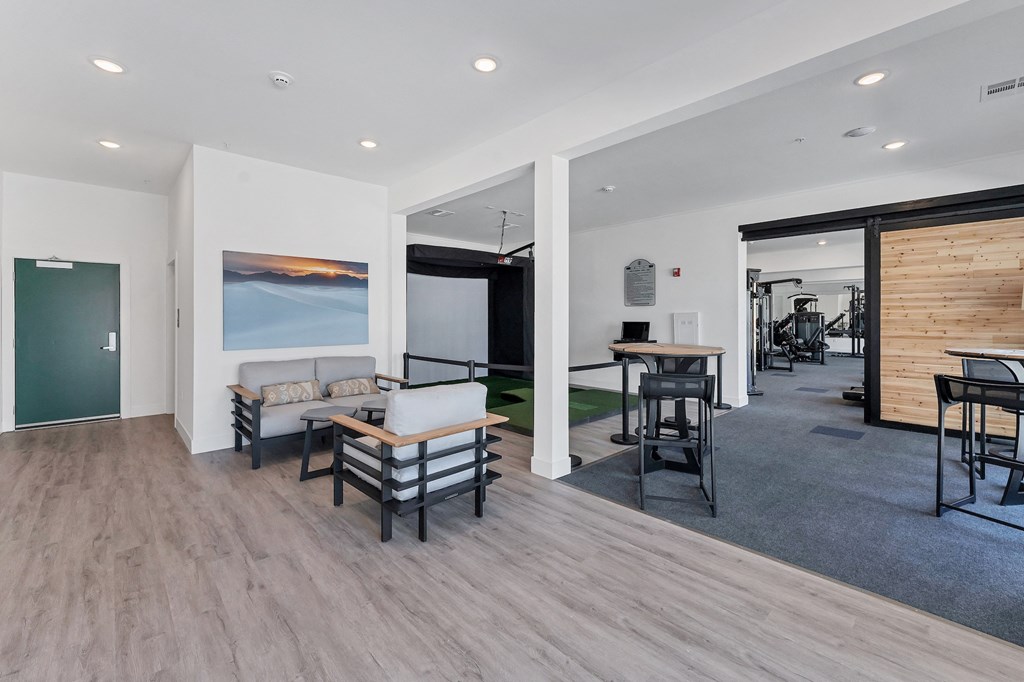 a living room with white walls and hardwood floors  at The Edison at Chapel Hills, Colorado, 80920