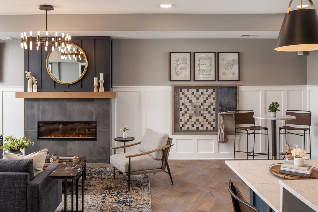 a living room with a fireplace and a dining room in the background at The Edison at Rice Creek, Shoreview, Minnesota
