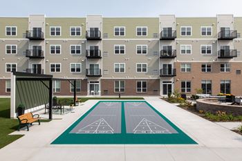 a tennis court is in the middle of an apartment building