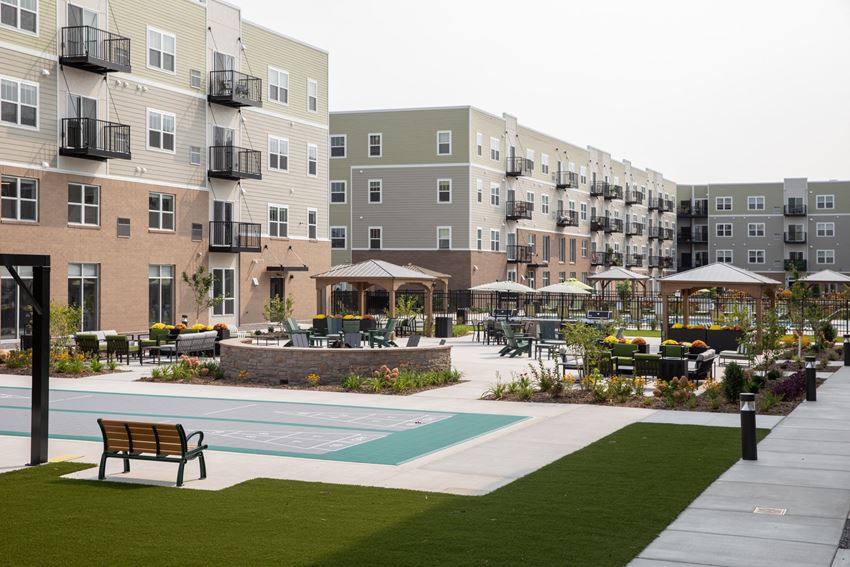 a courtyard with benches and tables at the flats at big tex apartments in san antonio