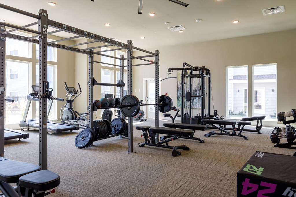 a fully equipped fitness room with weights benches and other exercise equipment at The Edison at Blue Springs, Blue Springs Missouri