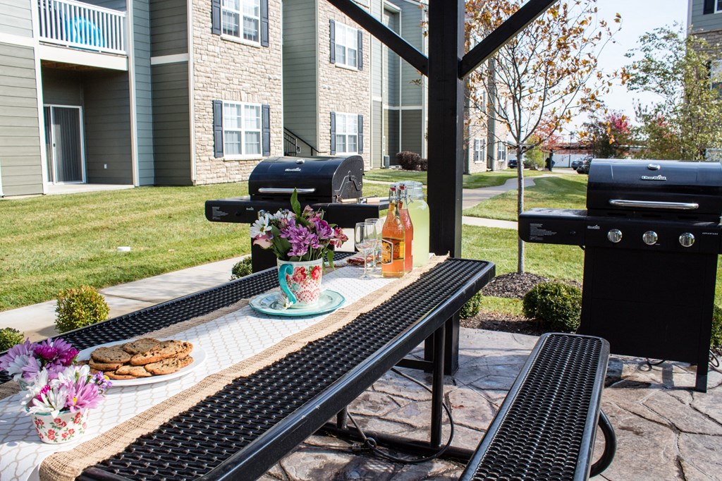 a patio with a table with food and drinks on it  at Aventura at Richmond, St. Peters, MO, 63376